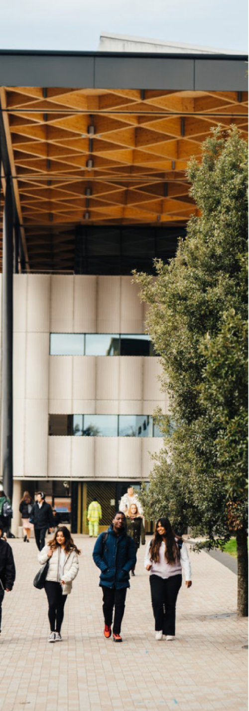 Photograph of students walking in front of the Lord Bhattacharyya building