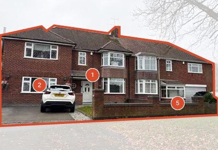 Photo of red brick houses set back from the street with a low brick wall and front car park.