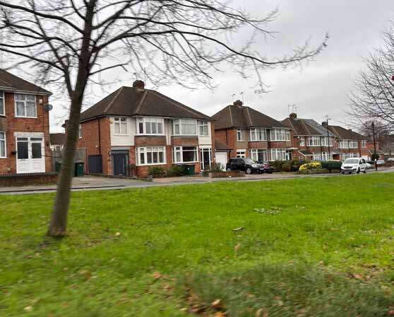 A photo of typical semi-detached houses overlooking green space