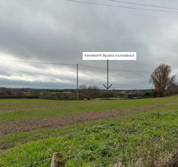 Open fields with an arrow points to the Kenilworth Bypass roundabout in the distance.