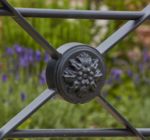 Close-up of an ornate black iron fence.